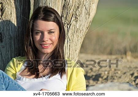 Beautiful girl looking at camera in countryside View Large Photo Image Stock Image - Beautiful girl looking at camera in countryside. Fotosearch