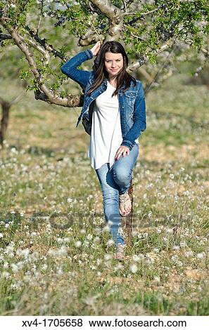 Stock Photo - Beautiful girl looking at camera in countryside. Fotosearch