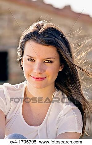 Beautiful girl looking at camera in countryside View Large Photo Image Stock Photography - Beautiful girl looking at camera in countryside. Fotosearch