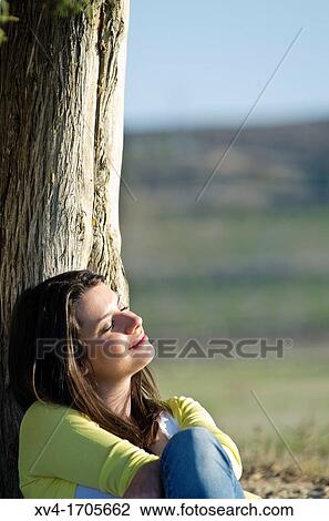 Beautiful girl relaxing in countryside View Large Photo Image Stock Image - Beautiful girl relaxing in countryside. Fotosearch