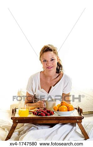 Beautiful girl take a breakfast on the bed in the morning View Large Photo Image Stock Image - Beautiful girl take a breakfast on the bed in the morning. Fotosearch