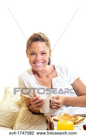 Beautiful girl take a breakfast on the bed in the morning View Large Photo Image Stock Image - Beautiful girl take a breakfast on the bed in the morning. Fotosearch