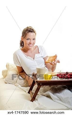 Beautiful girl take a breakfast on the bed in the morning View Large Photo Image Stock Image - Beautiful girl take a breakfast on the bed in the morning. Fotosearch