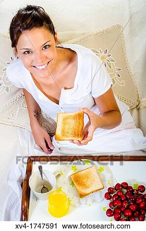 Beautiful girl take a breakfast on the bed in the morning View Large Photo Image Stock Image - Beautiful girl take a breakfast on the bed in the morning. Fotosearch