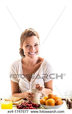 Beautiful girl take a breakfast on the bed in the morning View Large Photo Image Stock Photo - Beautiful girl take a breakfast on the bed in the morning. Fotosearch