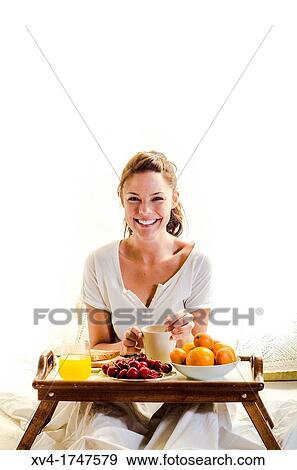 Beautiful girl take a breakfast on the bed in the morning View Large Photo Image Stock Photo - Beautiful girl take a breakfast on the bed in the morning. Fotosearch