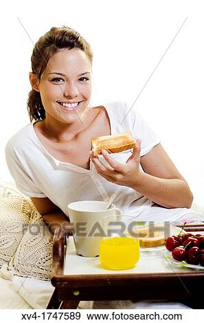 Beautiful girl take a breakfast on the bed in the morning View Large Photo Image Stock Photo - Beautiful girl take a breakfast on the bed in the morning. Fotosearch