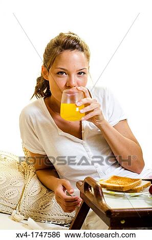 Beautiful girl take a breakfast on the bed in the morning View Large Photo Image Stock Photograph - Beautiful girl take a breakfast on the bed in the morning. Fotosearch