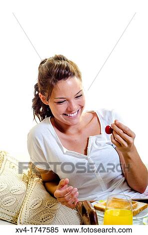 Beautiful girl take a breakfast on the bed in the morning View Large Photo Image Stock Photography - Beautiful girl take a breakfast on the bed in the morning. Fotosearch