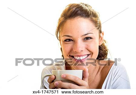 Stock Image - Beautiful girl take a coffee cup breakfast on the bed in the morning. Fotosearch