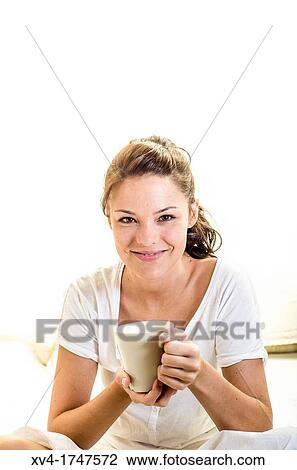 Beautiful girl take a coffee cup breakfast on the bed in the morning View Large Photo Image Stock Image - Beautiful girl take a coffee cup breakfast on the bed in the morning. Fotosearch