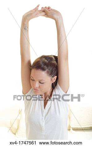 Beautiful girl weak up on bed with arms raised in the morning View Large Photo Image Stock Image - Beautiful girl weak up on bed with arms raised in the morning. Fotosearch