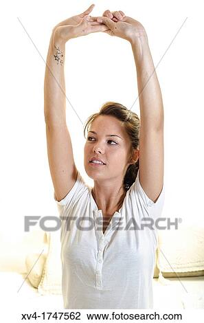 Beautiful girl weak up on bed with arms raised in the morning View Large Photo Image Stock Image - Beautiful girl weak up on bed with arms raised in the morning. Fotosearch