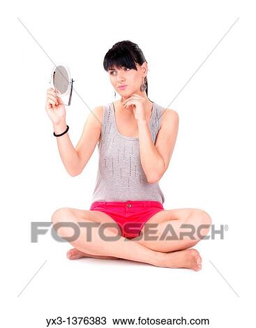 Stock Image - Beautiful girl with a mirror. Fotosearch