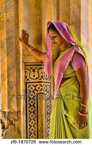 Beautiful graphic walls with colorful Hindu gentle woman posed at Amber Fort temple in Rajasthan Jaipur India View Large Photo Image Stock Photograph - Beautiful graphic walls with colorful Hindu gentle woman posed at Amber Fort temple in Rajasthan Jaipur India. Fotosearch