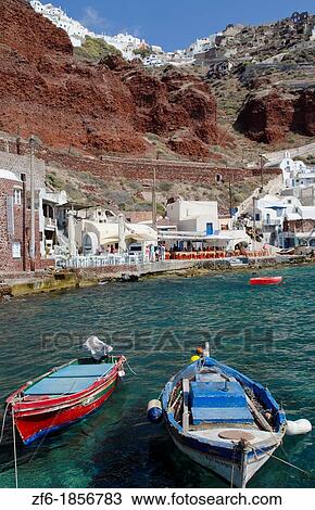 Beautiful harbor with fishing boats at water with Oia above on mountain in Santorini Greece in Greek Islands View Large Photo Image Stock Image - Beautiful harbor with fishing boats at water with Oia above on mountain in Santorini Greece in Greek Islands. Fotosearch