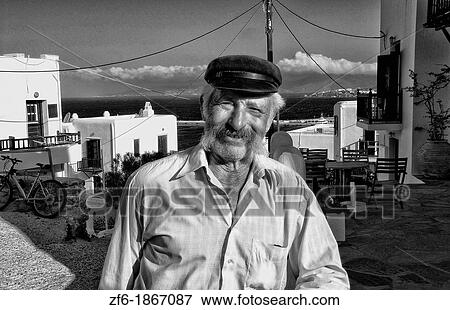 Beautiful island of Mykonos Greece with local fisherman portrait in hat View Large Photo Image Stock Photo - Beautiful island of Mykonos Greece with local fisherman portrait in hat. Fotosearch