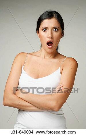 Beautiful Latin woman looks surprised at the camera View Large Photo Image Picture - Beautiful Latin woman looks surprised at the camera. Fotosearch