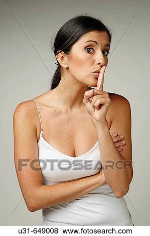 Beautiful Latin woman signals to be quiet View Large Photo Image Stock Photo - Beautiful Latin woman signals to be quiet. Fotosearch