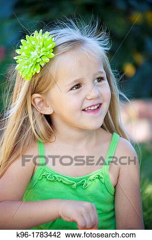 Stock Image - beautiful little girl in green. Fotosearch