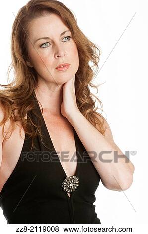 Stock Photo - Beautiful mature woman touching her neck.. Fotosearch