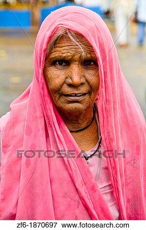 Beautiful old woman with colorful sari dress at Laxmi Narayan Temple near huge Chartarpur Road Temple in New Delhi India View Large Photo Image Stock Photo - Beautiful old woman with colorful sari dress at Laxmi Narayan Temple near huge Chartarpur Road Temple in New Delhi India. Fotosearch