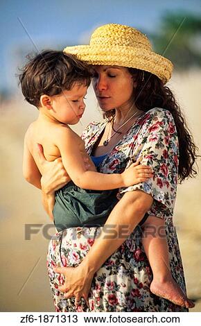 Beautiful pregnant hispanic mother with her young son with love together at beach with waves View Large Photo Image Stock Image - Beautiful pregnant hispanic mother with her young son with love together at beach with waves. Fotosearch