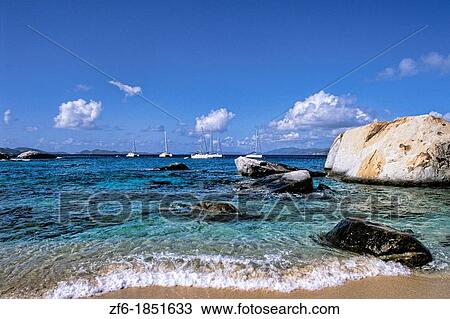 Beautiful rock formation boulder rocks with blue water ocean at The Baths of Virgin Gorda in British Virgin Islands View Large Photo Image Stock Image - Beautiful rock formation boulder rocks with blue water ocean at The Baths of Virgin Gorda in British Virgin Islands. Fotosearch