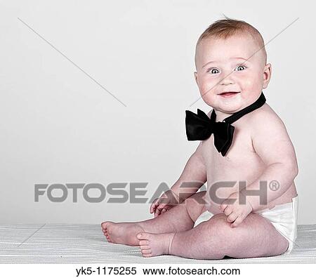 Stock Photography - Beautiful Shot of a 5 Month Old Baby Boy in Bow Tie against Grey Background. Fotosearch