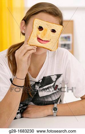 beautiful teenage girl, hiding behind a toast with cut mouth and eyes View Large Photo Image Stock Image - beautiful teenage girl, hiding behind a toast with cut mouth and eyes. Fotosearch