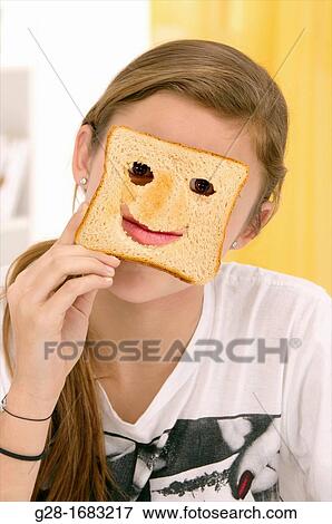 beautiful teenage girl, hiding behind a toast with cut mouth and eyes View Large Photo Image Stock Photo - beautiful teenage girl, hiding behind a toast with cut mouth and eyes. Fotosearch