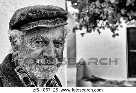 Beautiful village of Oia with old local man in Greek cap in Santorini in Greek Islands in Greece Europe View Large Photo Image Stock Photography - Beautiful village of Oia with old local man in Greek cap in Santorini in Greek Islands in Greece Europe. Fotosearch