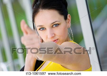 beautiful woman is pretending to shoot with a finger View Large Photo Image Stock Photo - beautiful woman is pretending to shoot with a finger. Fotosearch