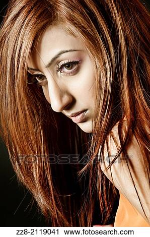Stock Image - Beautiful woman looking away.. Fotosearch