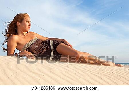 Beautiful woman posing on the beach View Large Photo Image Stock Photograph - Beautiful woman posing on the beach. Fotosearch