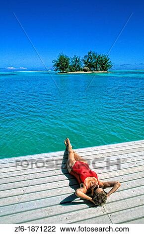 Beautiful woman relaxing by ocean in beautiful Tahiti in French Polynesia in the South Pacific on holiday View Large Photo Image Stock Image - Beautiful woman relaxing by ocean in beautiful Tahiti in French Polynesia in the South Pacific on holiday. Fotosearch
