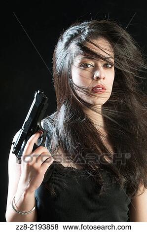 Stock Photo - Beautiful woman with a gun.. Fotosearch