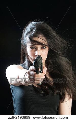 Stock Photo - Beautiful woman with a gun.. Fotosearch