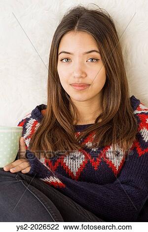 Beautiful young adult female holding a cup of hot chocolate. View Large Photo Image Stock Image - Beautiful young adult female holding a cup of hot chocolate.. Fotosearch