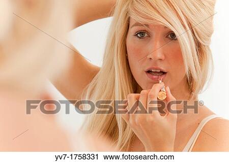 Beautiful young blonde makeup in the mirror View Large Photo Image Stock Image - Beautiful young blonde makeup in the mirror. Fotosearch