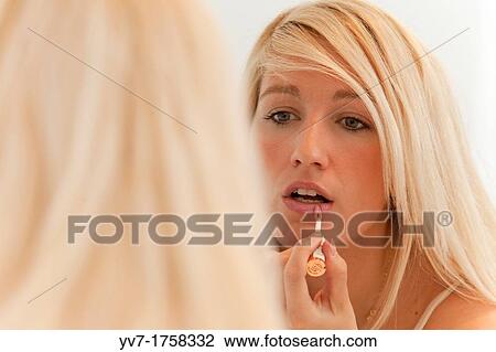 Beautiful young blonde makeup in the mirror View Large Photo Image Stock Image - Beautiful young blonde makeup in the mirror. Fotosearch