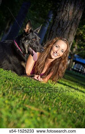 Stock Image - Beautiful young caucasian woman with her German Shepherd dog in Spokane, Washington, USA. Fotosearch