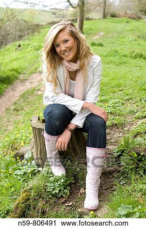 Beautiful young woman enjoying being outside in a green natural environment View Large Photo Image Stock Image - Beautiful young woman enjoying being outside in a green natural environment. Fotosearch