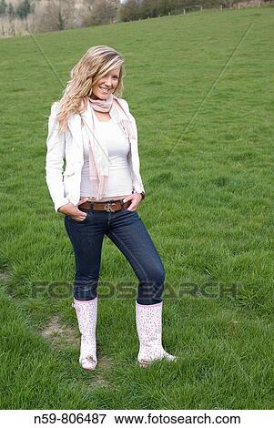 Beautiful young woman enjoying being outside in a green natural environment View Large Photo Image Stock Photo - Beautiful young woman enjoying being outside in a green natural environment. Fotosearch
