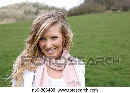 Beautiful young woman enjoying being outside in a green natural environment View Large Photo Image Stock Photo - Beautiful young woman enjoying being outside in a green natural environment. Fotosearch