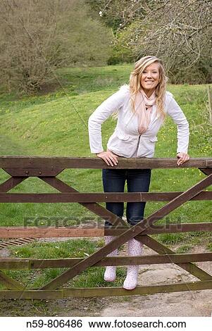 Beautiful young woman enjoying being outside in a green natural environment View Large Photo Image Stock Photograph - Beautiful young woman enjoying being outside in a green natural environment. Fotosearch