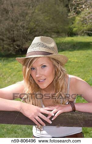 Beautiful young woman enjoying being outside in a green natural environment View Large Photo Image Stock Photograph - Beautiful young woman enjoying being outside in a green natural environment. Fotosearch