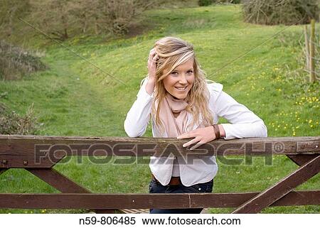 Stock Photography - Beautiful young woman enjoying being outside in a green natural environment. Fotosearch