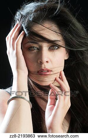 Stock Image - Beautiful young woman hands touching face.. Fotosearch