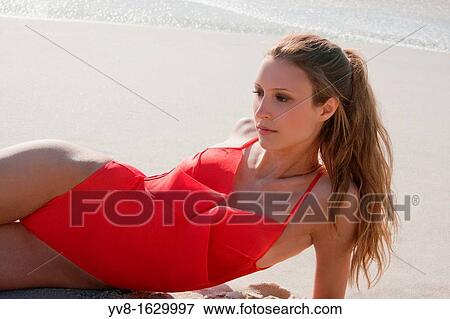 Stock Photo - Beautiful young woman in red swimsuit. Fotosearch